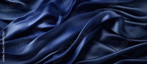 Dark background made of navy blue silk satin fabric with elegant waves and space for design Suitable for Christmas birthday anniversary award templates