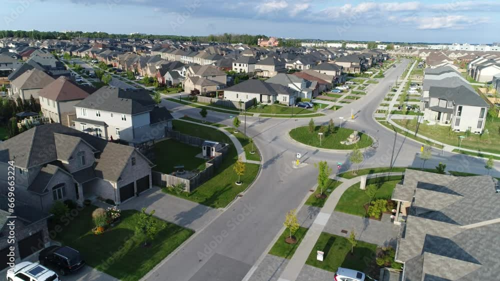 Descending Aerial Near Roundabout In Upscale Middle Class Neighbourhood With Shadows Descending Aerial Near Roundabout In Upscale Middle Class Neighbourhood With Shadows