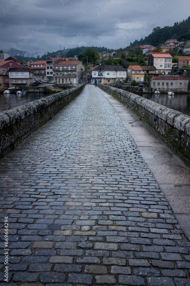 Going through the medieval bridge of Pontesampayo, Pontevedra, Spain.
