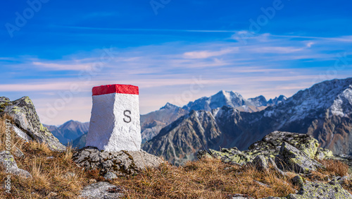 Fototapeta Naklejka Na Ścianę i Meble -  The boundary stone on the ridge of high mountains. The mountain ridge of the Western Tatras is a natural Poland and Slovakia border.