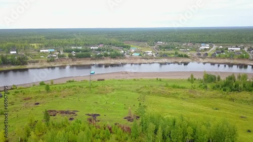 A copter is flying over the Dakches River in the Turukhansky district of the Krasnoyarsk Territory and the village of Sandakches. photo