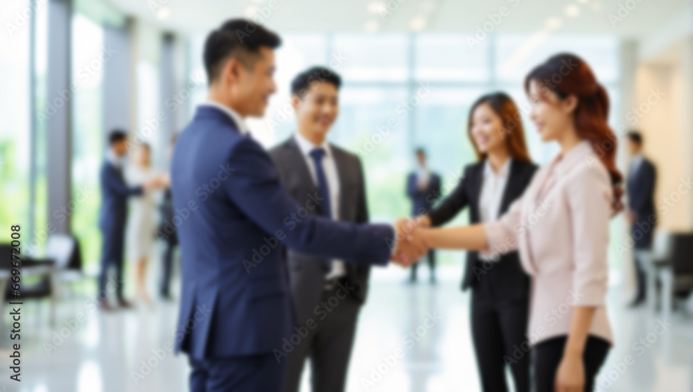 blur background of businessman and woman handshake