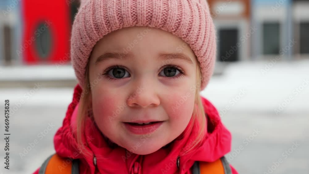 Winter portrait of little 2 years old girl smiling looking at camera Winter portrait of little 2 years old girl smiling looking at camera