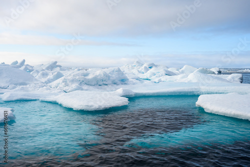 Melting ice at the edge of the ice pack in the arctic ocean, ice bergs floating in the ocean in the far north, signs of global warming and climate change 