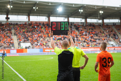 Team manager man shows players substitution during football match. © Dziurek
