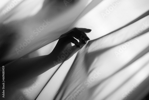 Elegant hand shadow on flowing satin fabric.