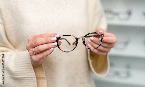 A Woman With a Pair of Glasses in Her Hands. A woman holding a pair of glasses in her hands