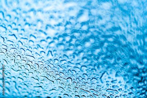 Close Up of Rainy Window with Water Droplets. A close up of a window with drops of water on it
