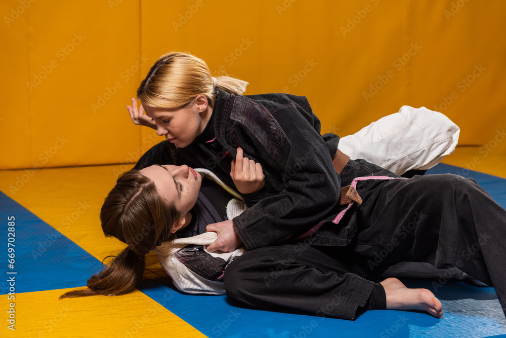 Young girls practice Brazilian jiu jitsu in the gym Young girls practice Brazilian jiu jitsu in the gym