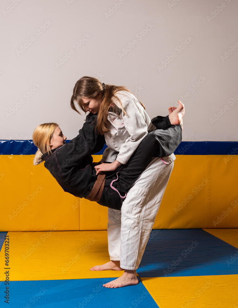 Young girls practice Brazilian jiu jitsu in the gym Young girls practice Brazilian jiu jitsu in the gym