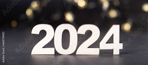 2024 wooden numbers with bokeh background. Happy new year 2024 banner