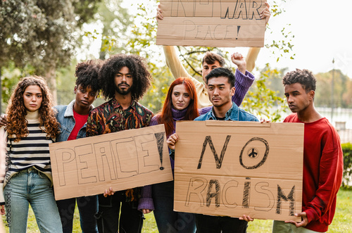 Group of multicultural teenage activists protesting against war and violence in the streets, and racism, in the city. Generation Z protesters photo