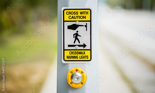 Traffic sign. Push button to turn on crosswalk warning light photo