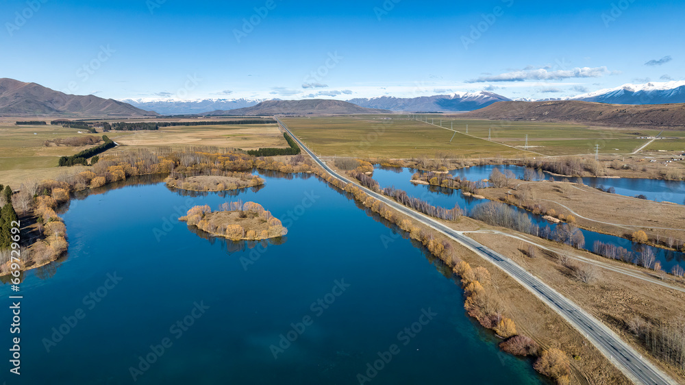 Beautiful panoramic scenic drone photography above remote and rural Lake Benmore and its mountain range