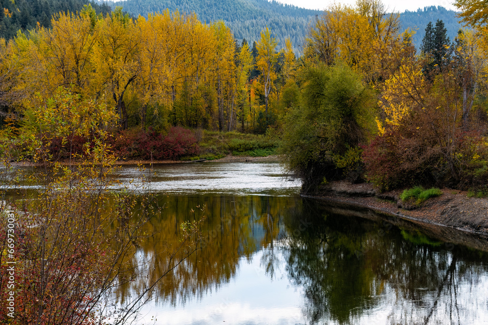 Autumn reflections on the Wenatchee River.  Vibrant red, yellow and orange foliage.