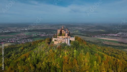Aerial drone view of medieval Hohenzollern castle on top of hill in autumn, Baden-Wurttemberg, Germany. High quality 4k footage photo