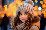 portrait of a little girl in winter clothes on the background of Christmas lights in winter