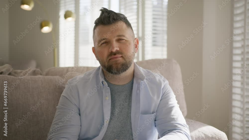 Portrait of smiling handsome middle aged man in living room on sunny day. Cinematic slow motion shot on RED camera. Concept of lifestyle, achievement, father, successful entrepreneur business owner Portrait of smiling handsome middle aged man in living room on sunny day. Cinematic slow motion shot on RED camera. Concept of lifestyle, achievement, father, successful entrepreneur business owner