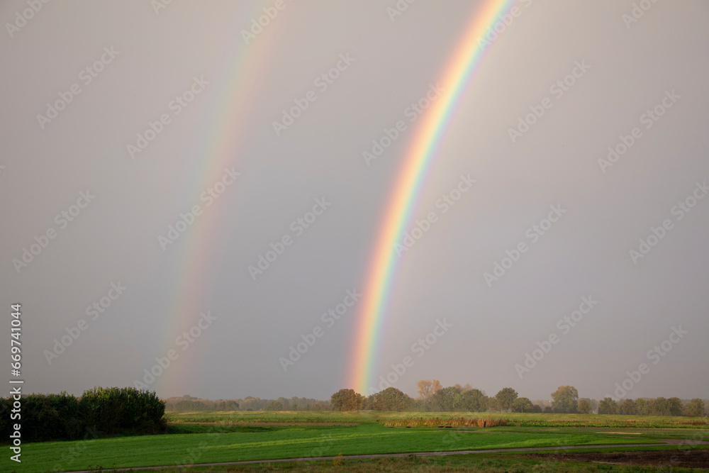 Rural landscape with double rainbow and beautiful sky colors after rain in the Netherlands in early autumn Rural landscape with double rainbow and beautiful sky colors after rain in the Netherlands in early autumn