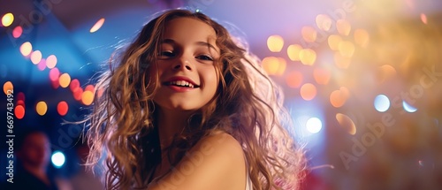 Portrait of a beautiful young girl with long curly hair in a nightclub.