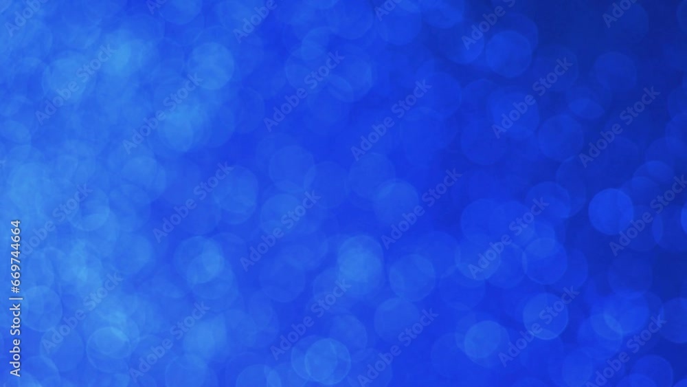 Front on abstract dark blue sparkly soft out of focus bokeh calm tranquil background constant moving pattern Front on abstract dark blue sparkly soft out of focus bokeh calm tranquil background constant moving pattern