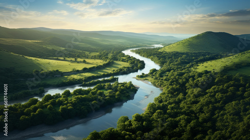 A winding river meandering through a sunlit landscape of rolling hills photo