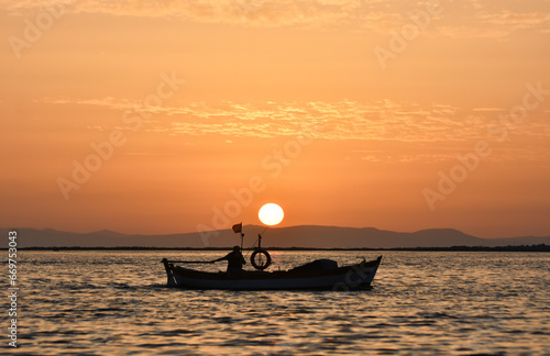 Fishing boat on a sea at sunset. 