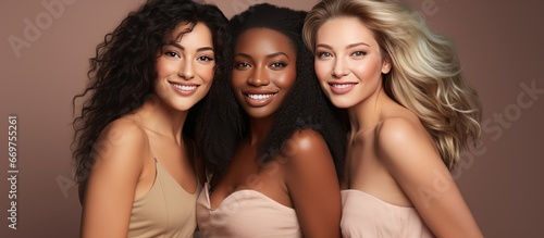 Group of confident women with diverse skin tones posing happily in a studio