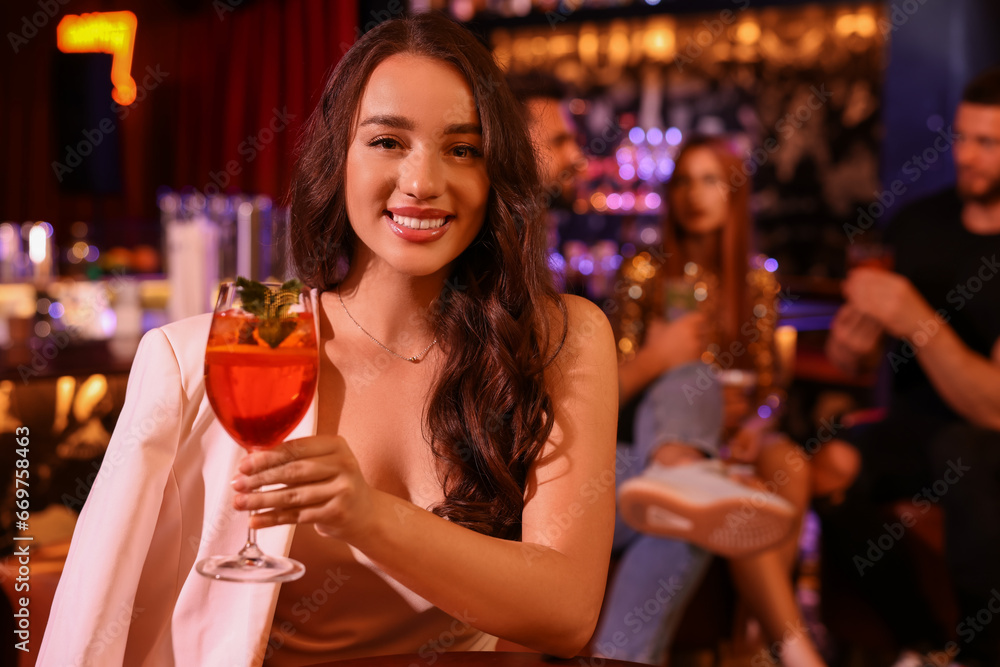 Friends spending time together in bar. Beautiful woman with fresh alcoholic cocktail, space for text Friends spending time together in bar. Beautiful woman with fresh alcoholic cocktail, space for text