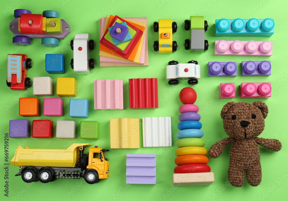 Different children's toys on green background, flat lay Different children's toys on green background, flat lay