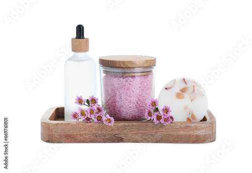 Glass container of pink sea salt  bottle with essential oil  natural soap and beautiful chrysanthemum flowers isolated on white