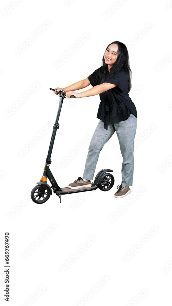 Full length profile shot of Asian female student riding an electric scooter Full length profile shot of Asian female student riding an electric scooter