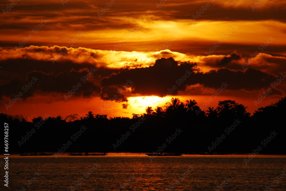 Tropical amazing dramatic golden sky on sunset over scenic river lake seascape ocean. Silhouette tranquil season wilderness serene landscape. Tranquil lake countryside sunrise seaside reflection