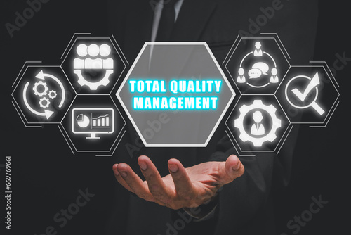 Foto Total quality management concept, Businessman hand holding total quality management icon on virtual screen
