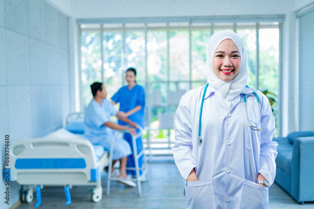 Obraz premium Medical Hospital Portrait: Healthcare and medical concept. Medicine muslim Doctor with a stethoscope in hand and Patients come to the hospital background.