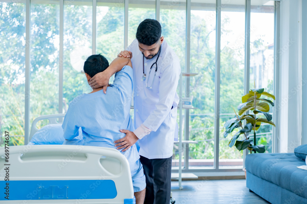 Doctor physiotherapist treating lower back pain patient after while giving exercising treatment on stretching in the hospital, Rehabilitation physiotherapy concept. Doctor physiotherapist treating lower back pain patient after while giving exercising treatment on stretching in the hospital, Rehabilitation physiotherapy concept.
