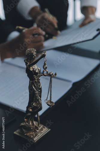 Business and lawyers discussing contract papers with brass scale on desk in office. Law, legal services, advice, justice and law concept picture with film grain effect