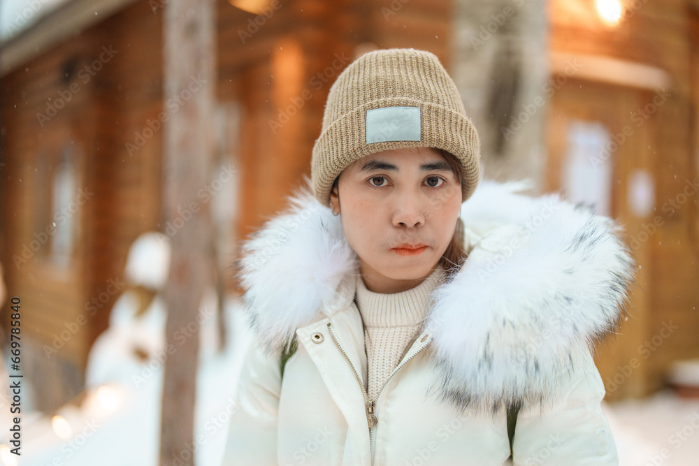 Woman tourist Visiting in Furano, Traveler in Sweater sightseeing Ningle Terrace Cottages with Snow in winter. landmark and popular for attractions in Hokkaido, Japan. Travel and Vacation concept Woman tourist Visiting in Furano, Traveler in Sweater sightseeing Ningle Terrace Cottages with Snow in winter. landmark and popular for attractions in Hokkaido, Japan. Travel and Vacation concept