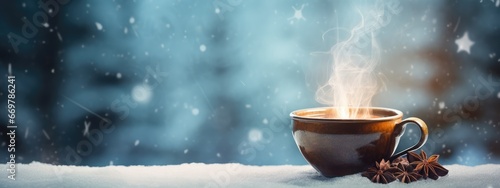 A cup of hot warming tea in winter weather overlooking the snowy forest. hot winter medicinal drink. Black tea. © AndErsoN