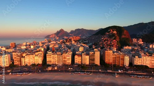 Aerial Forward Shot Of Buildings In City Near Mountains And Sea Against Sky At Sunrise - Rio de Janeiro, Brazil photo