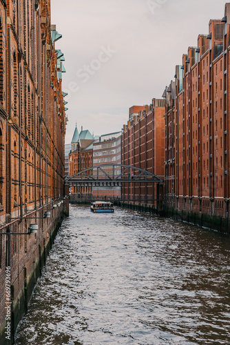 Famous Speicherstadt warehouse district and a touristic boat in Hamburg, Germany