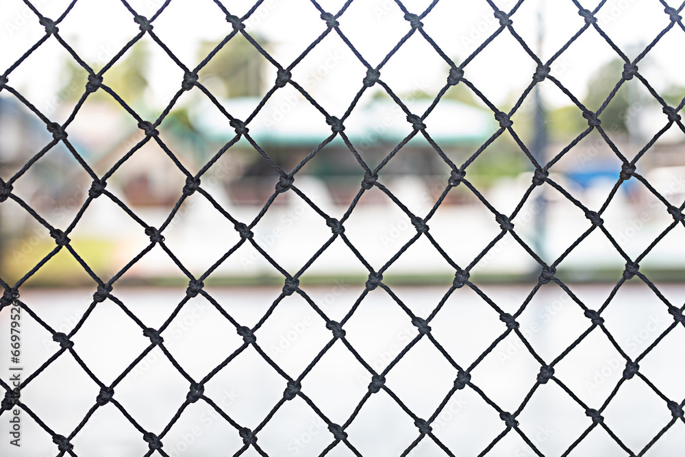 Black netting in plastic blocks the area of the football stadium. Black netting in plastic blocks the area of the football stadium.