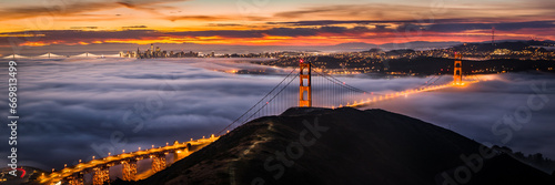 San Francisco Golden Gate Bridge at Sunrise Covered in Fog / Clouds photo