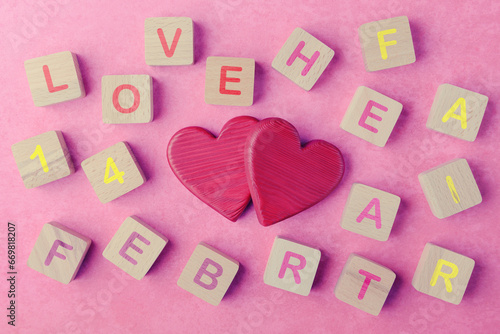 Two Valentines hearts and wooden cubes with lettering Love, 14 Feb, Heart, Fair. Valentine’s day concept
