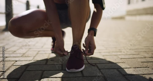 Feet, hands and tie shoelace, running outdoor for fitness with person ready for exercise. Sneakers, start run and workout with race or marathon, health and wellness with athlete and sports in nature photo