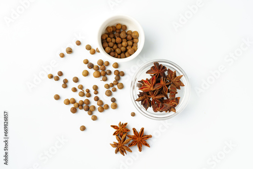 Allspice and anise stars on white background