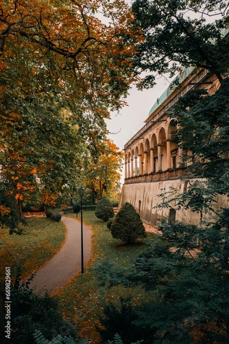 Autumn park in Prague, red foliage on the paths