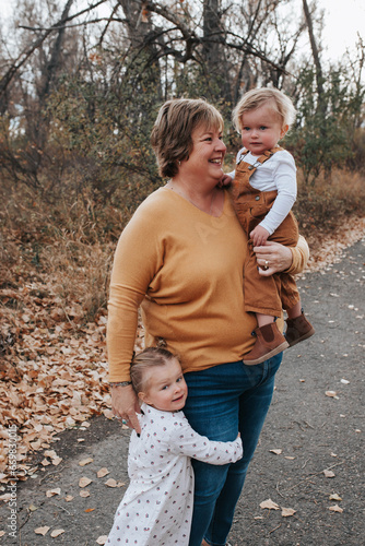 Grandma loves on grandkids on a fall day photo