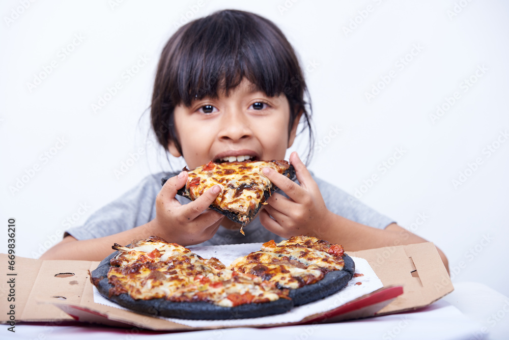 Hungry little girl enjoys Italian pizza alone on a white background Hungry little girl enjoys Italian pizza alone on a white background