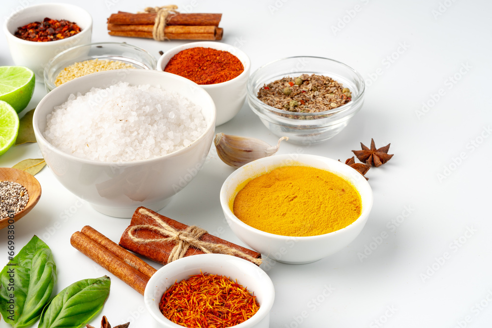 Bowls with spices and cooking ingredients on white background Bowls with spices and cooking ingredients on white background